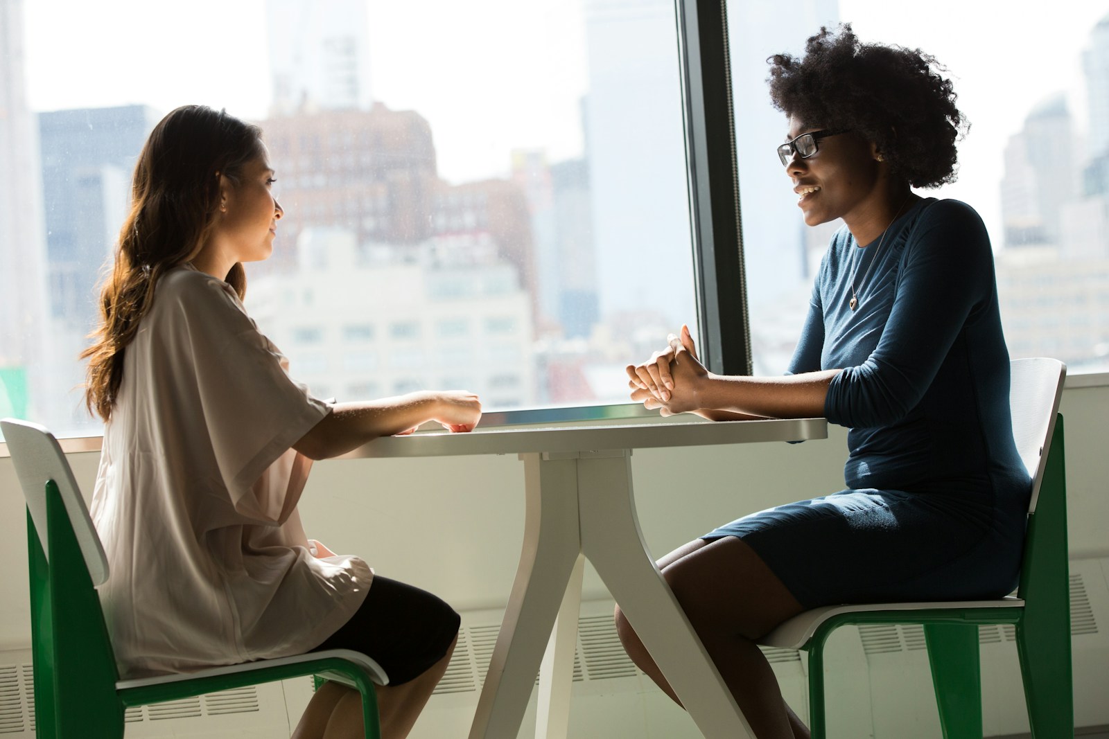 two women sitting beside table and talking things to talk about in therapy