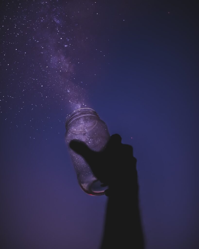person holding glass jar