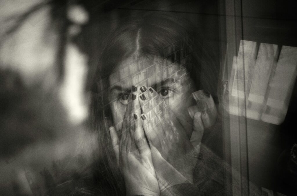 a woman covering her face with her hands