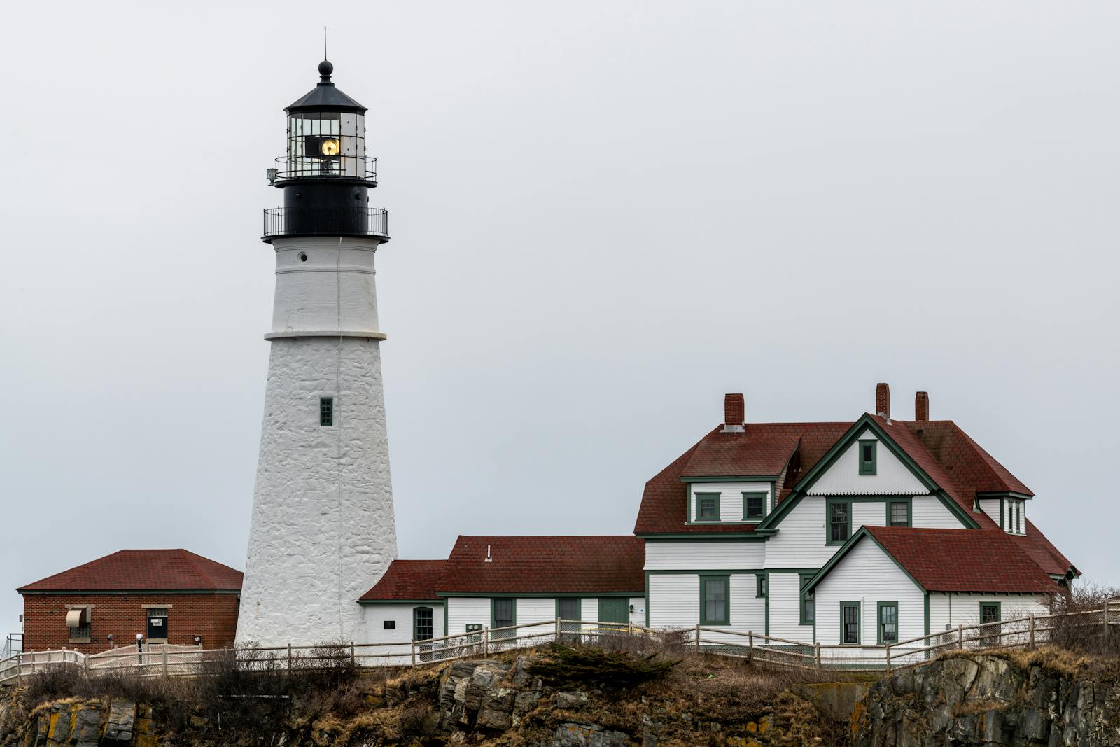 A picturesque view of Portland Head Light on a cloudy day, highlighting its architectural beauty by the coastline. dbt therapy in portland