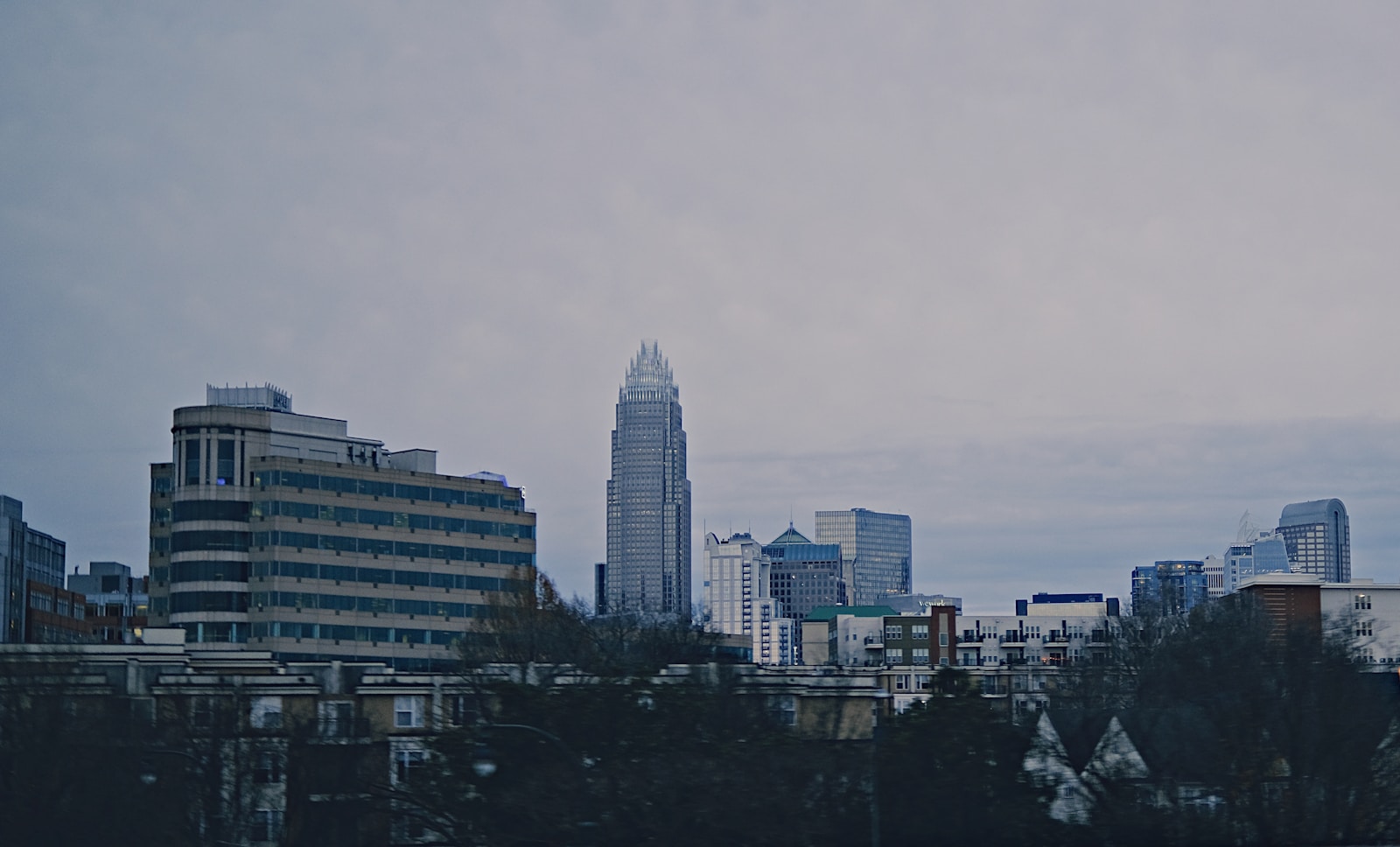 a plane flying over a city with tall buildings dbt therapy in charlotte