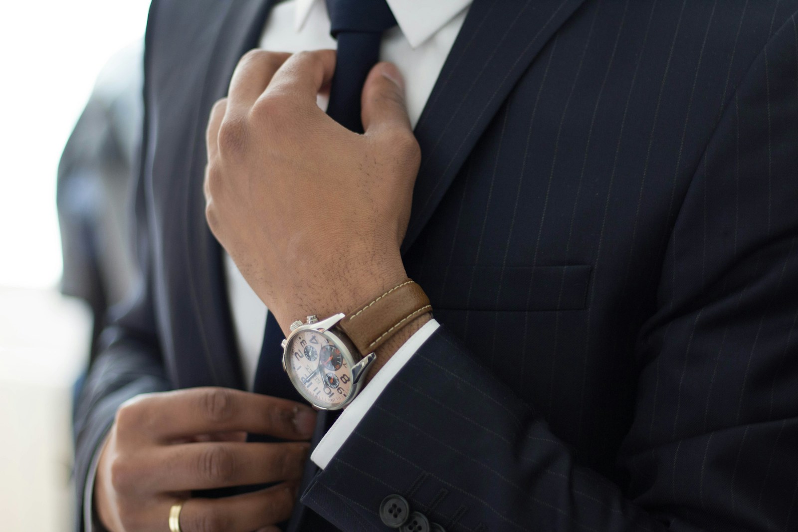 man wearing watch with black suit diffusion of responsibility