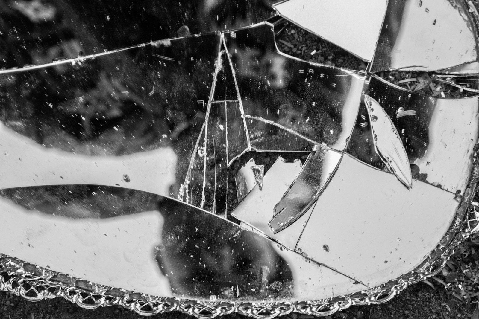 a broken mirror sitting on top of a sidewalk Trauma