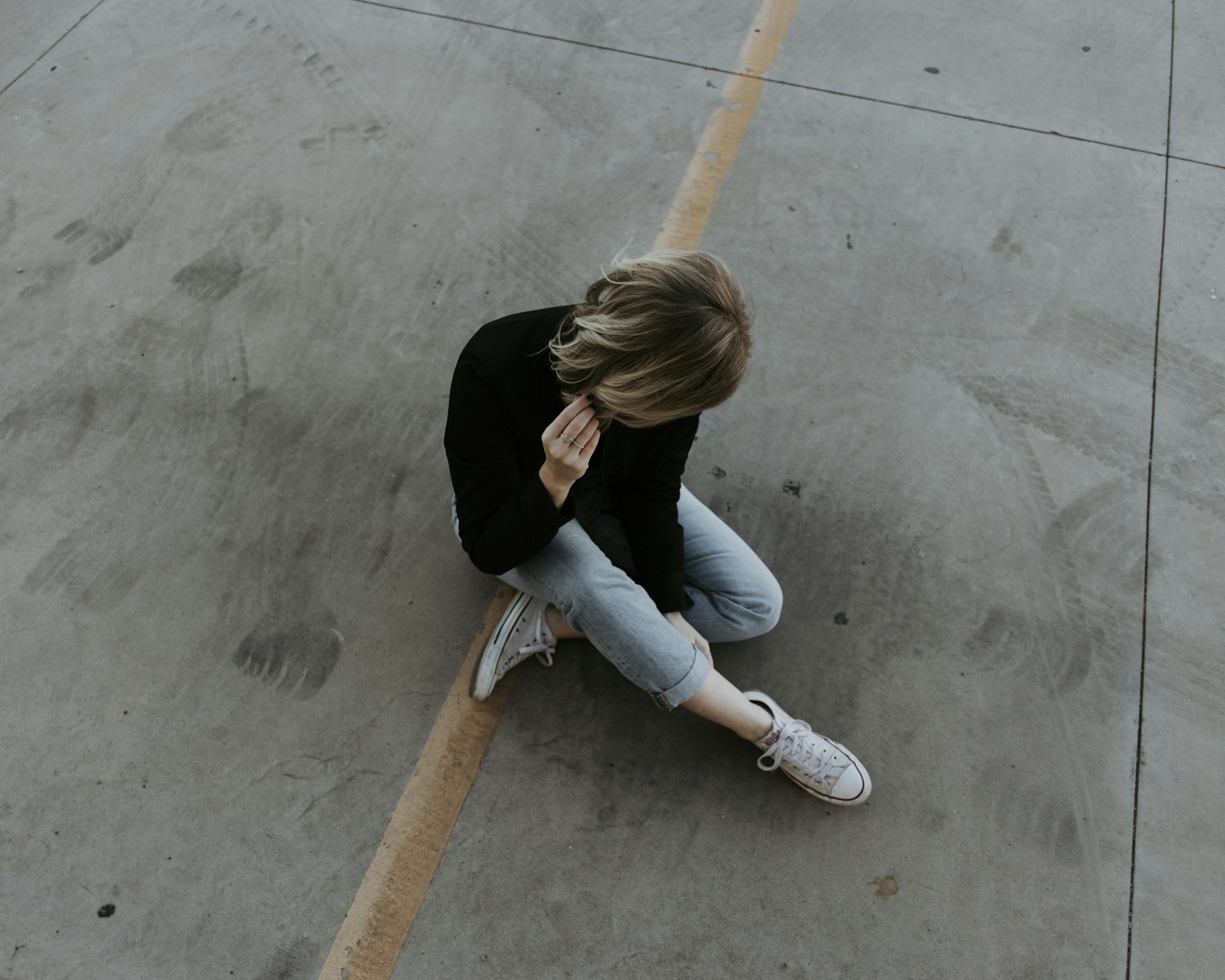 woman sitting on pavement Adjustment Disorder