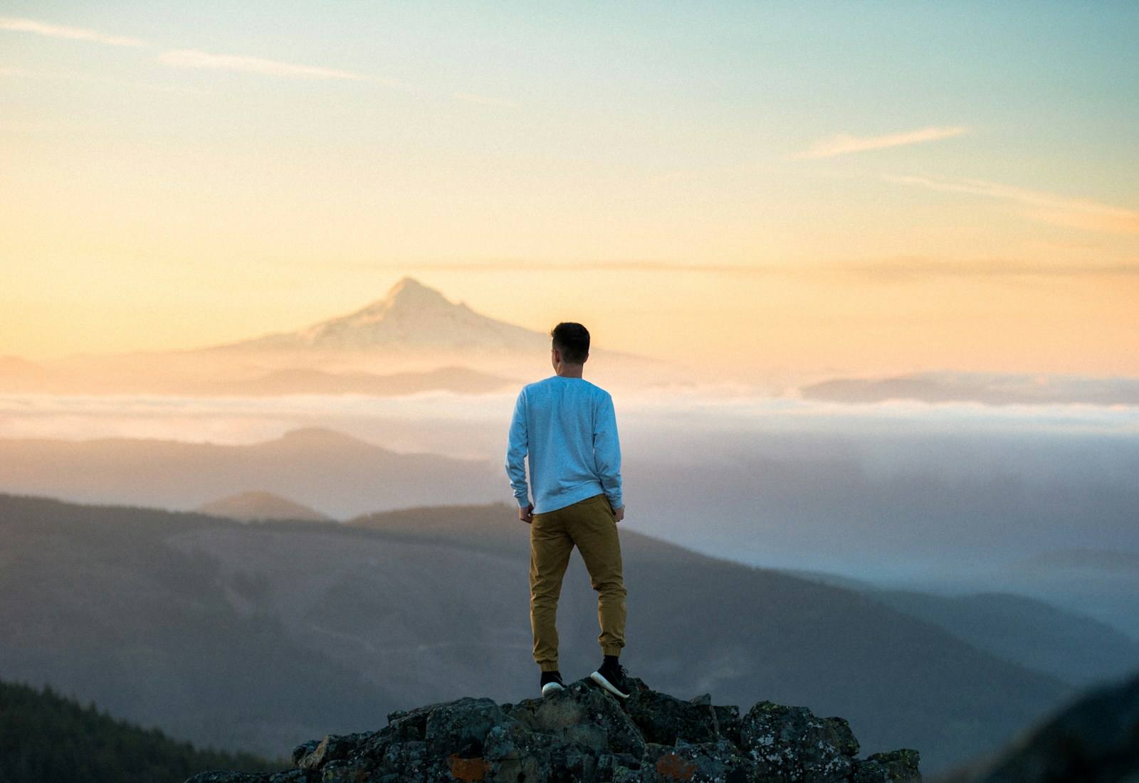 Photo by Tim Bogdanov man standing on top of mountain Strength-Based Therapy