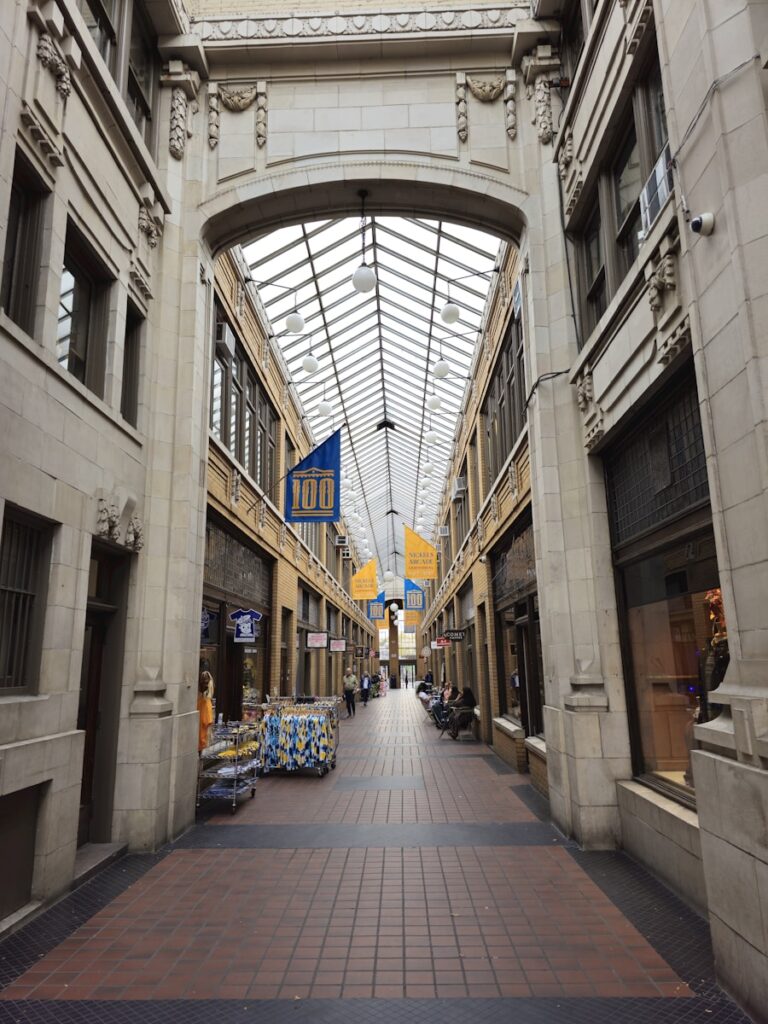 a walkway in a building with a skylight above it
