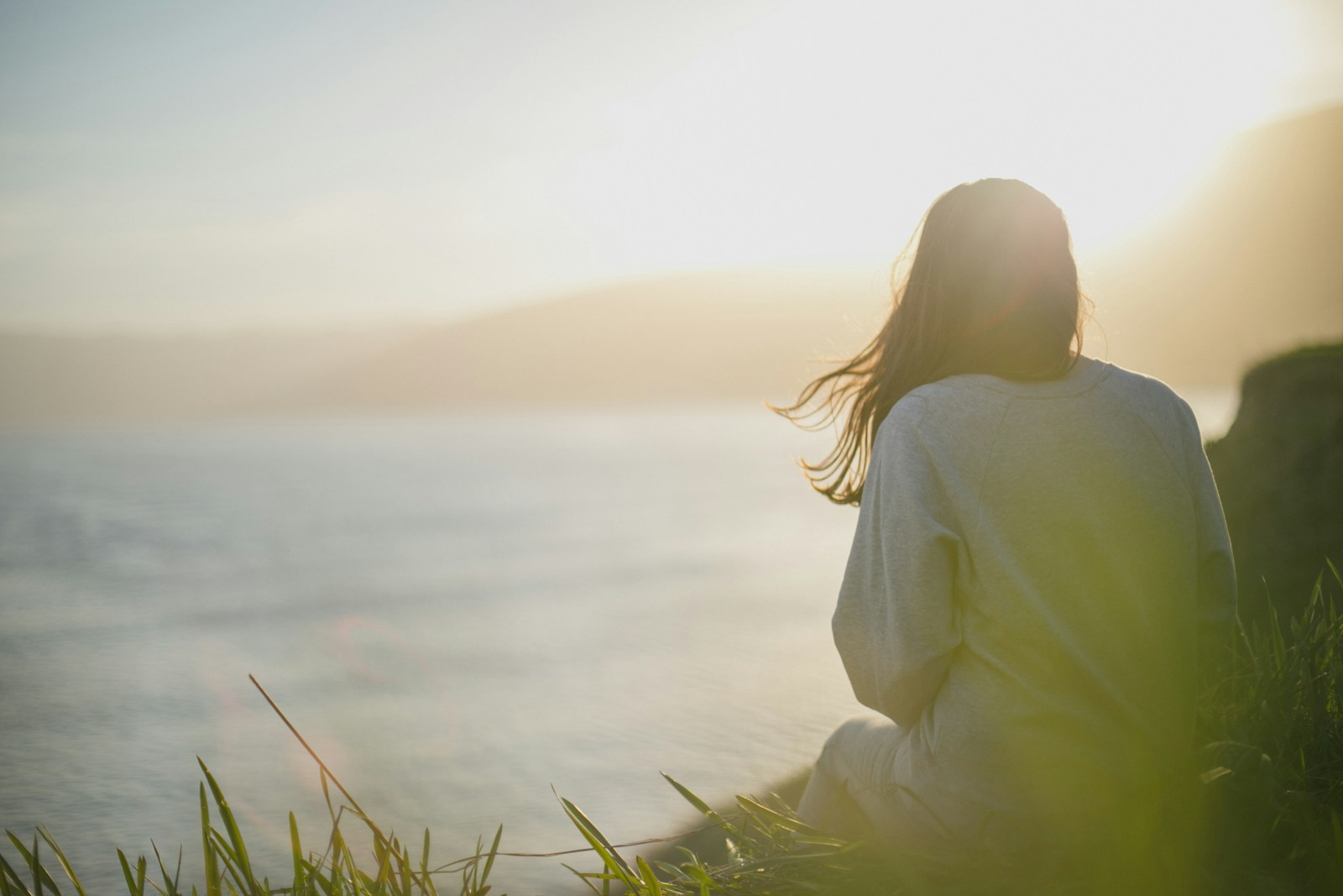 Photo by Artem Kovalev woman wearing gray long-sleeved shirt facing the sea Trauma-Focused CBT