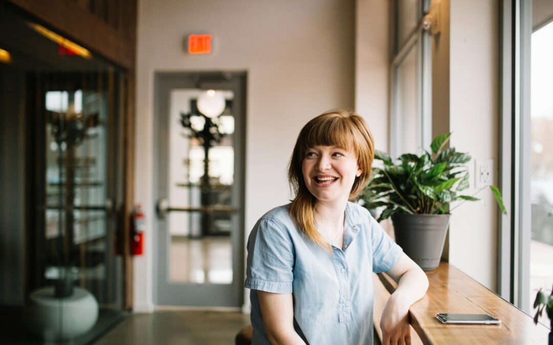 woman sitting in front of brown wooden table Positive Psychotherapy
