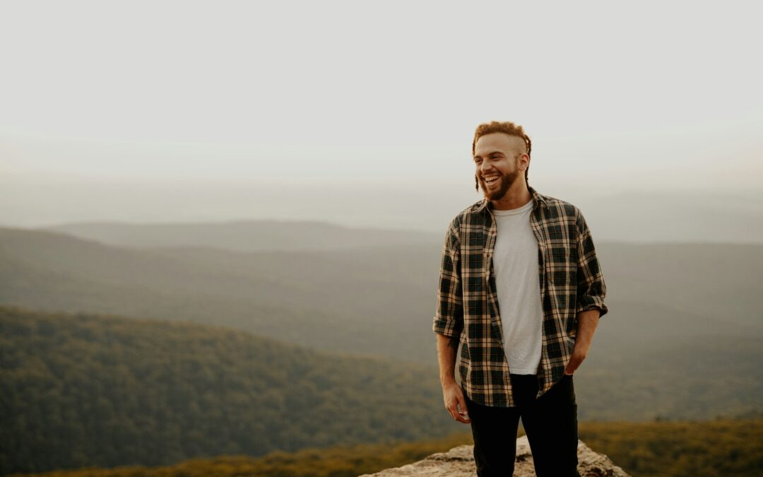 man in brown and white plaid button up shirt standing on brown rock during daytime Existential Therapy