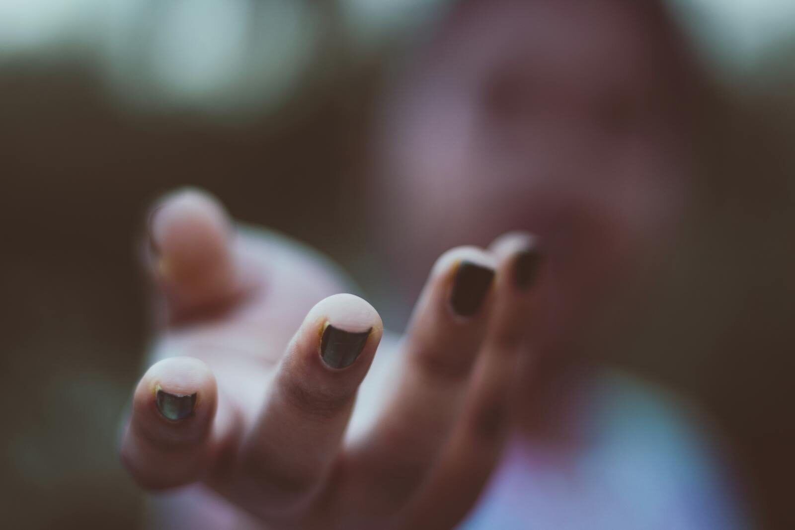 Photo by Rahul Pandit Blurred close-up of a hand reaching out with darkly polished nails, artistic depth of field. Acute vs Chronic Conditions: How Ongoing Illness Impacts Mental Health and Stress Levels