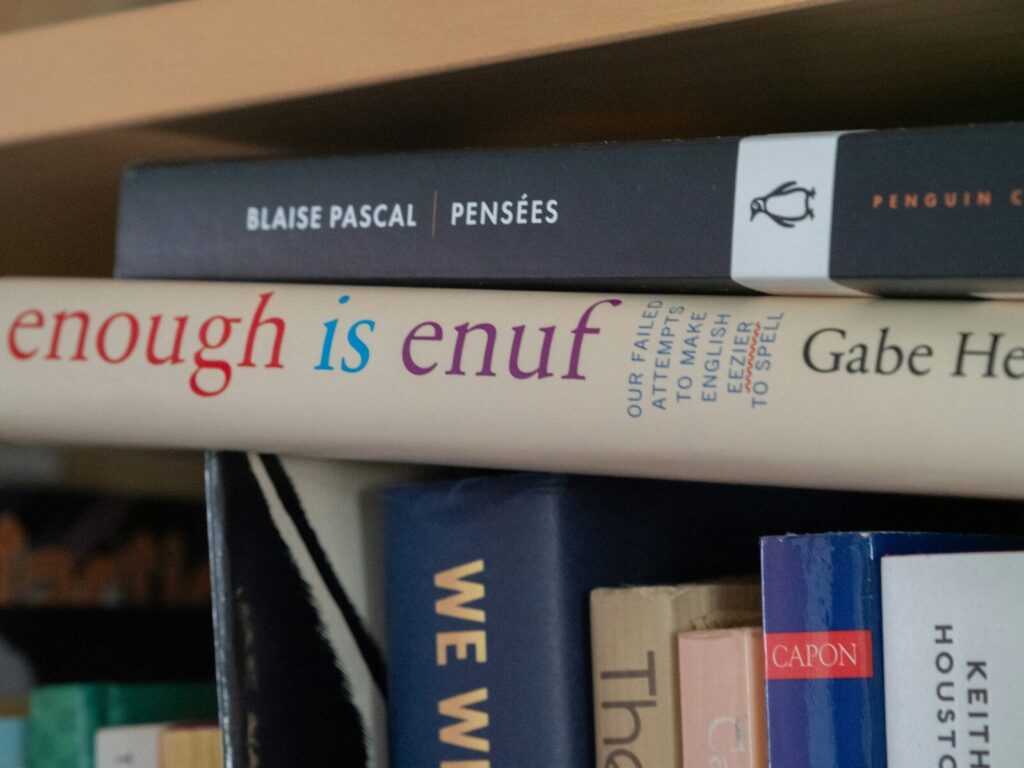 Stack of books on a shelf, close-up.