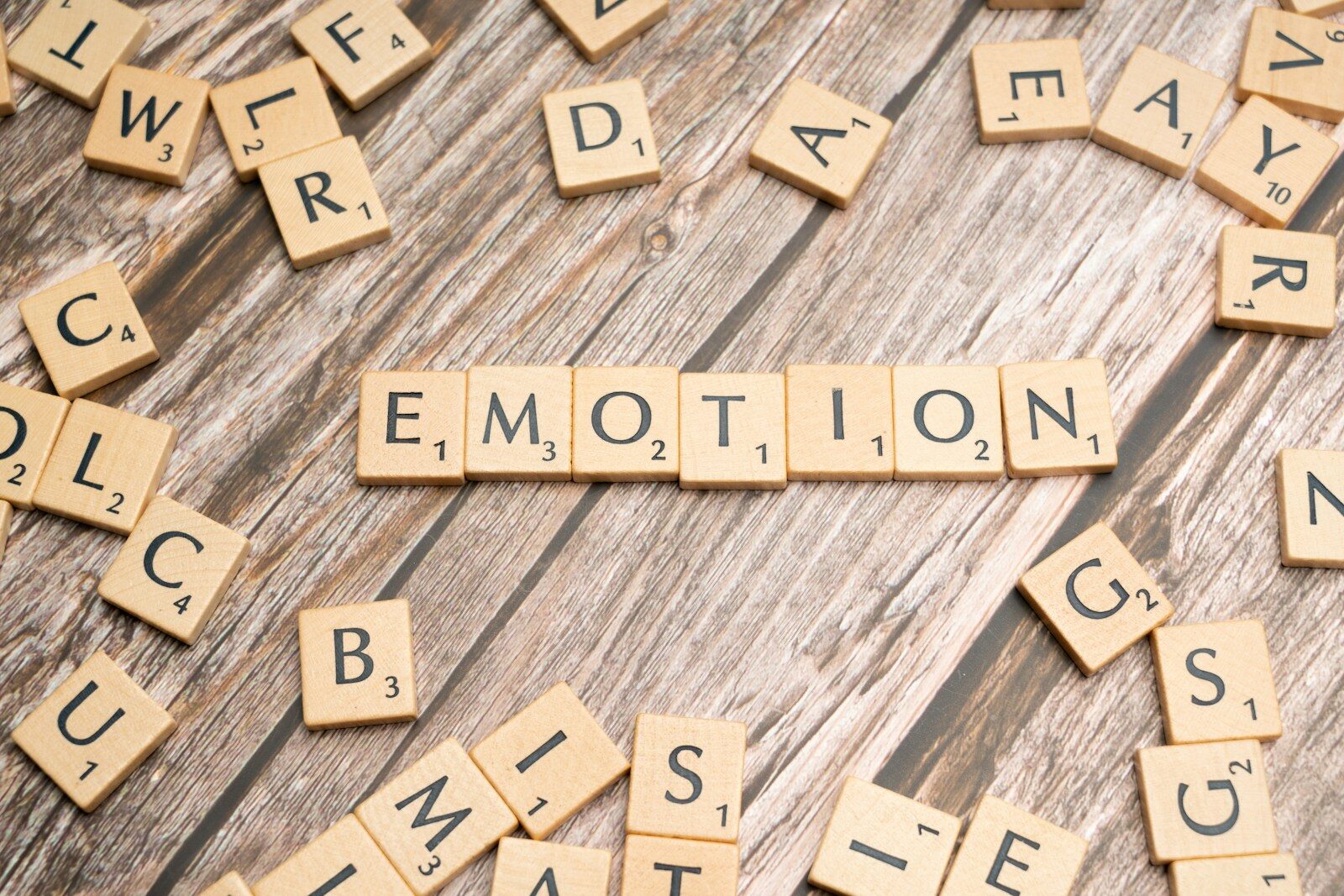 Photo by Markus Winkler scrabble tiles spelling the word emotion on a wooden surface