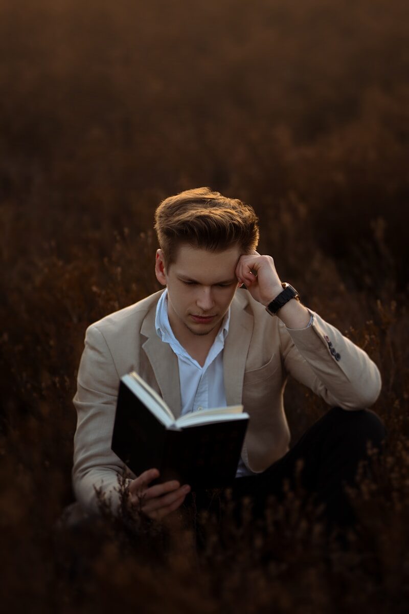 Photo by Leandra Rieger a young man wearing a suit and tie