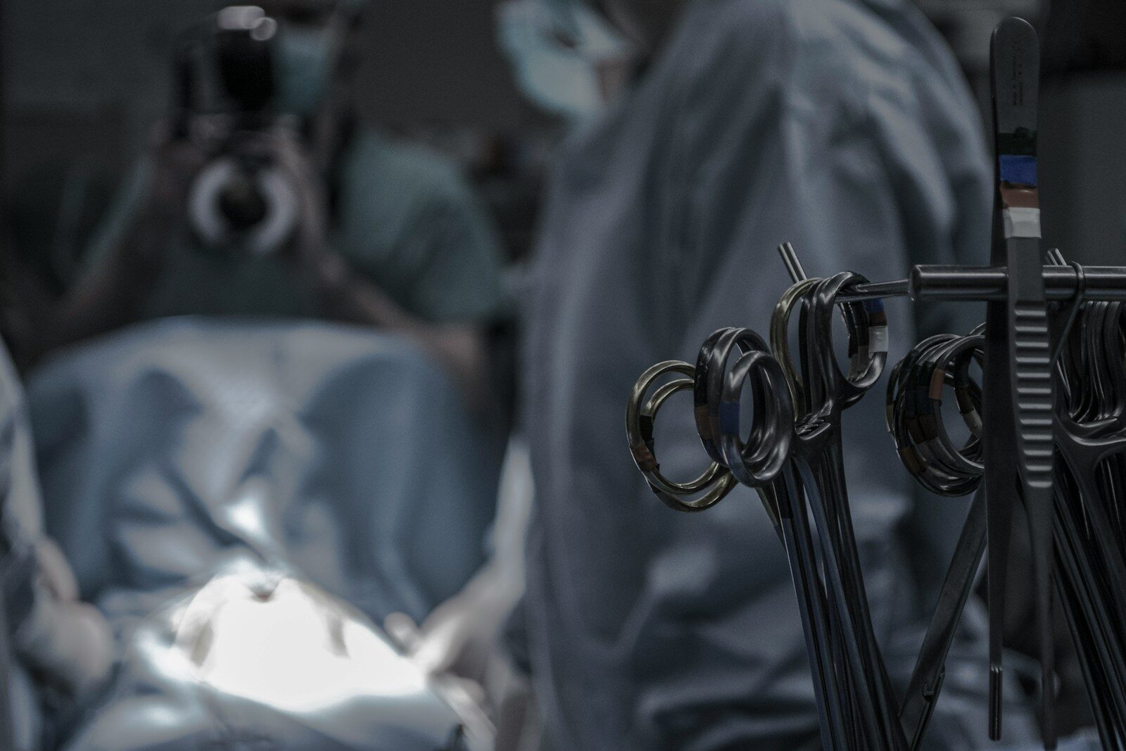 gray surgical scissors near doctors in operating room Navigating the Types of Surgery with a Healthy Mind: The Importance of Mental Health in the Healing Process