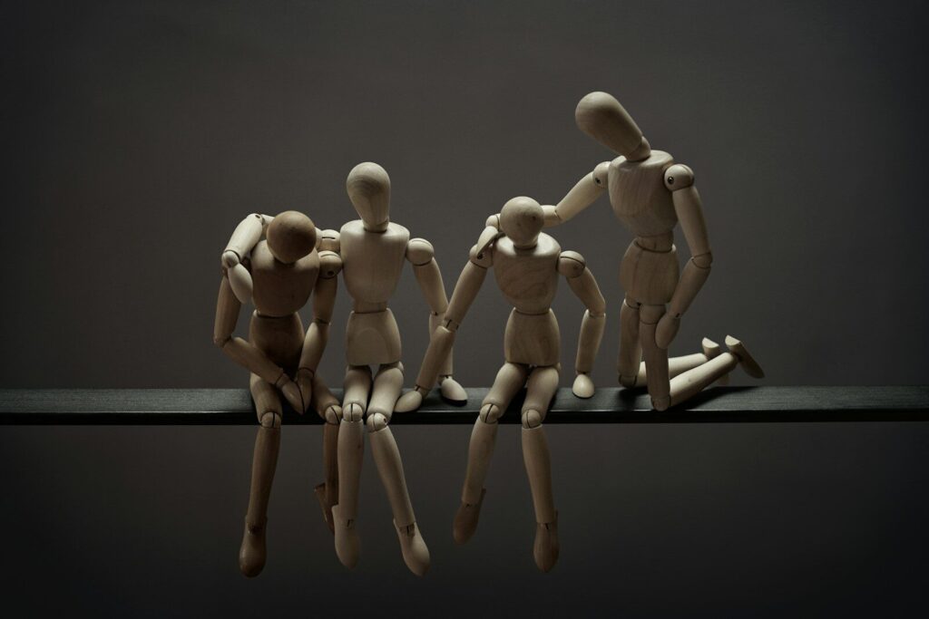 a group of wooden mannequins sitting on top of a table