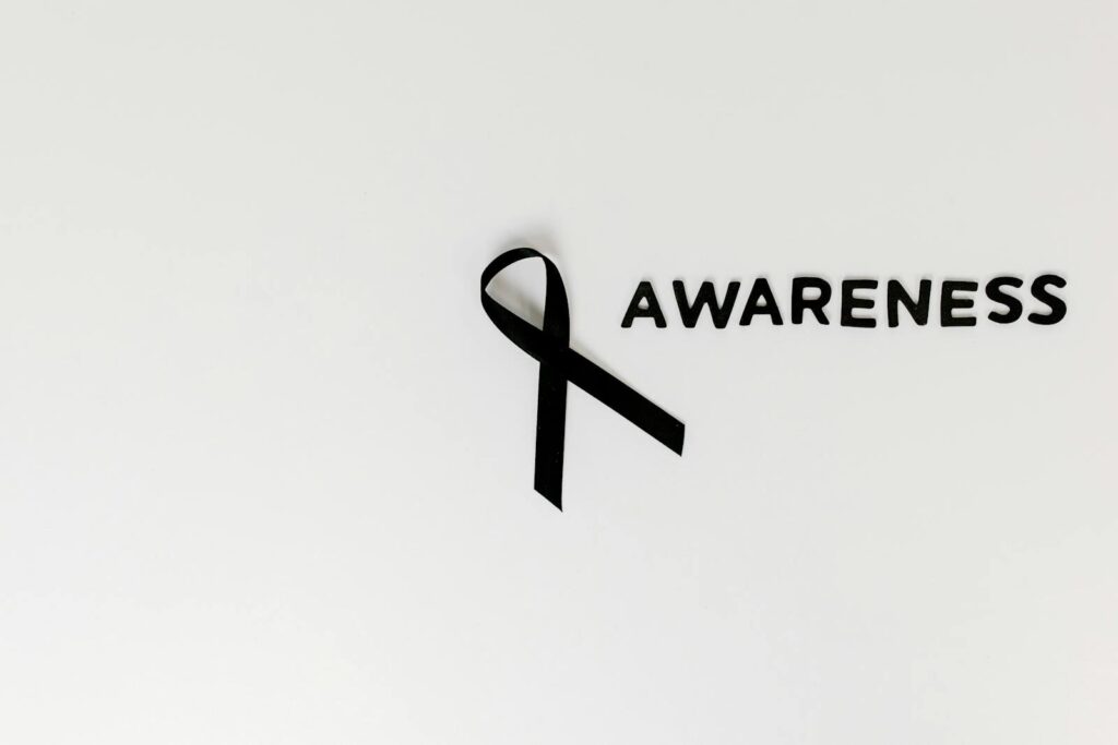 Conceptual image of a black ribbon with 'awareness' text on white background.