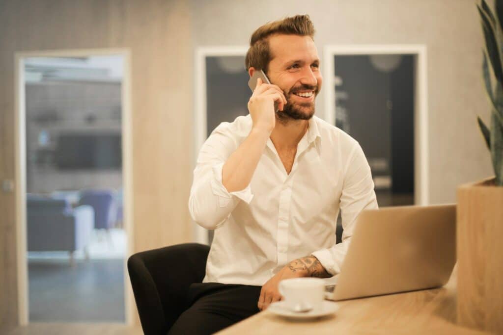 man using smartphone on chair Business Owner Mental Health: Success Does Not Cancel Out Stress