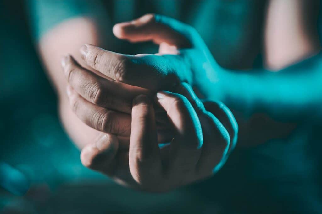 a close up of a person holding their hands together