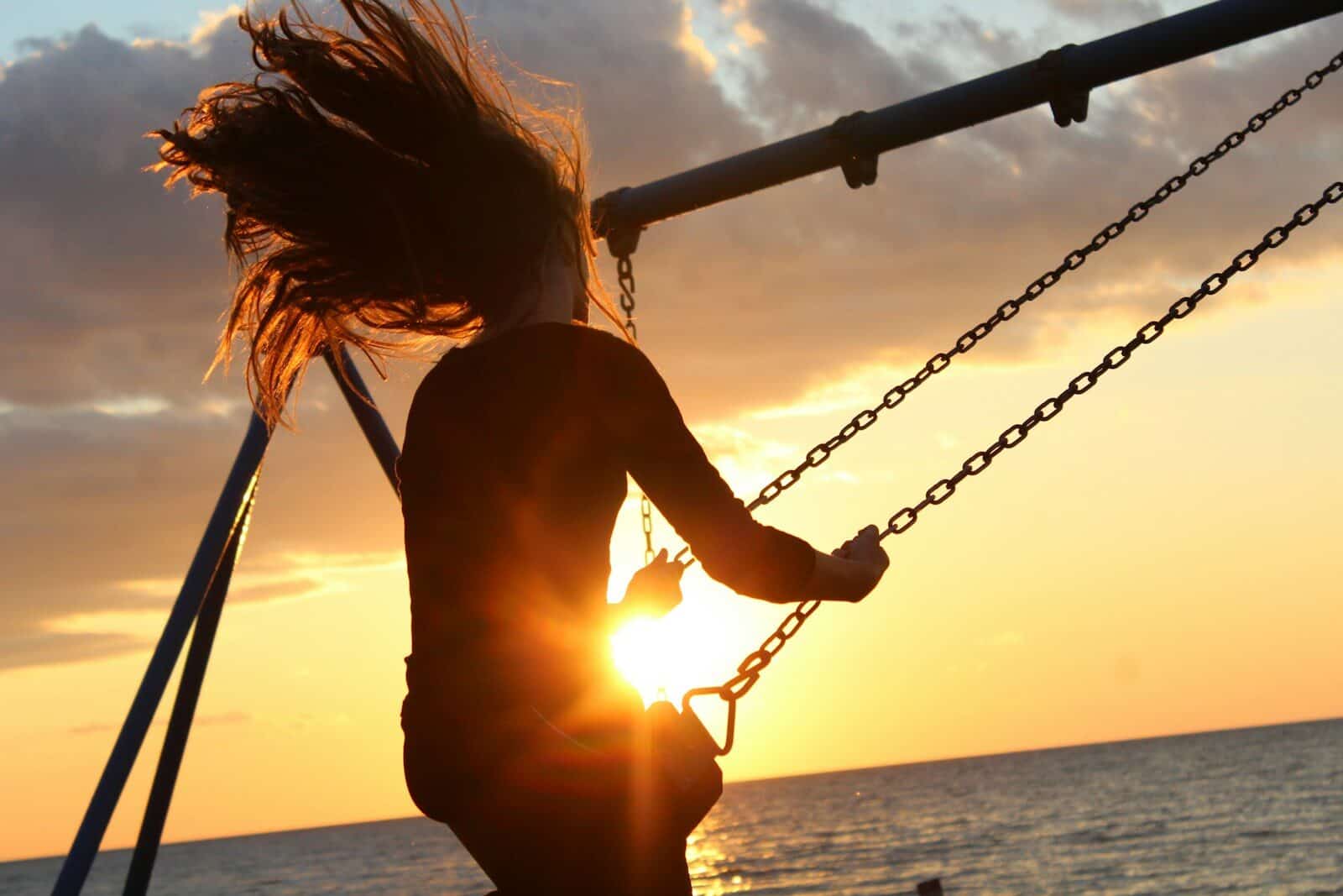 woman riding on swing during sunset DBT Distress Tolerance Skills for Stressful, Overwhelming Moments