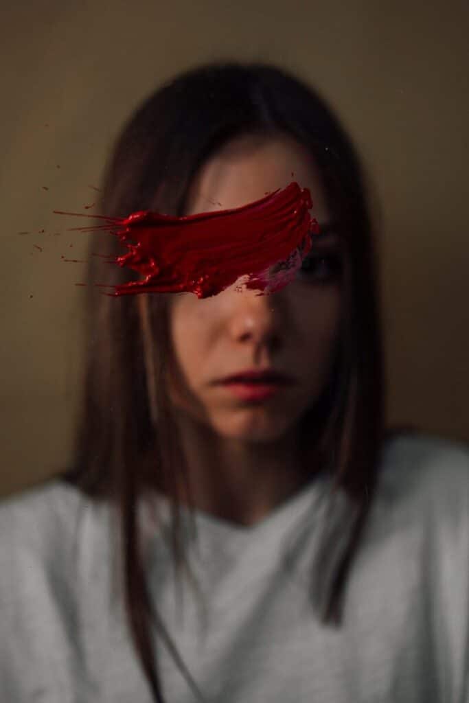 a woman with red paint on her face