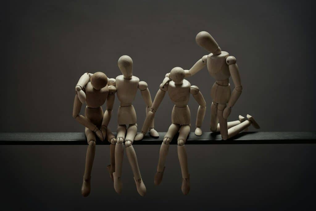 a group of wooden mannequins sitting on top of a table