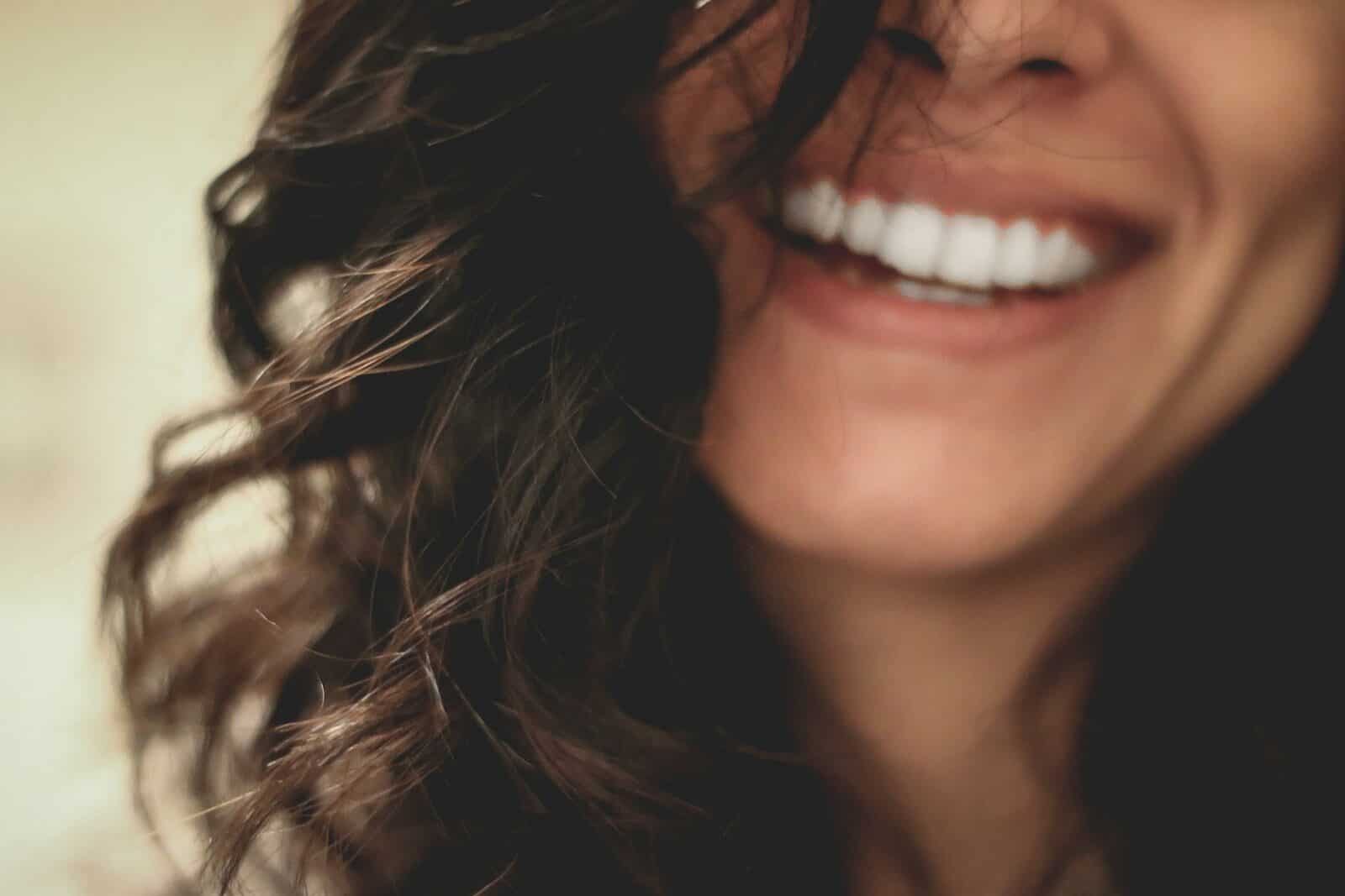 long black haired woman smiling close-up photography Disruptive Mood Dysregulation Disorder vs. ADHD: What’s the Difference?